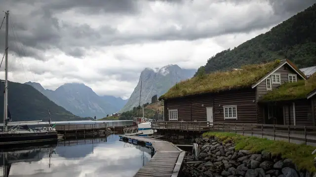 Naust og båter langs en stille fjord i Møre og Romsdal